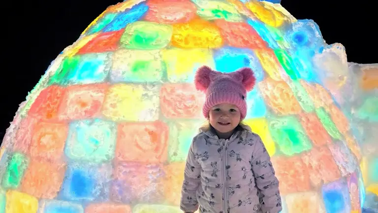 American Family Builds Rainbow Igloo in Their Yard During Freezing Weather